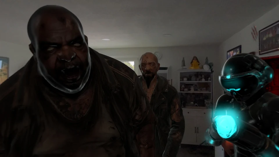 Two infected characters crowd the foreground of a real living room beside a robot with a glowing cyan hand.